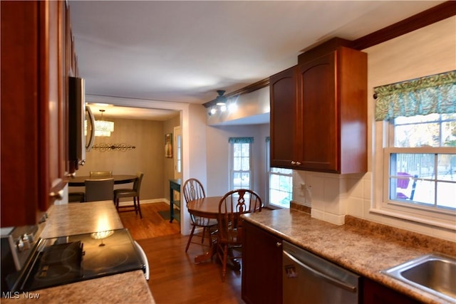 kitchen featuring range, dishwasher, sink, backsplash, and dark hardwood / wood-style floors