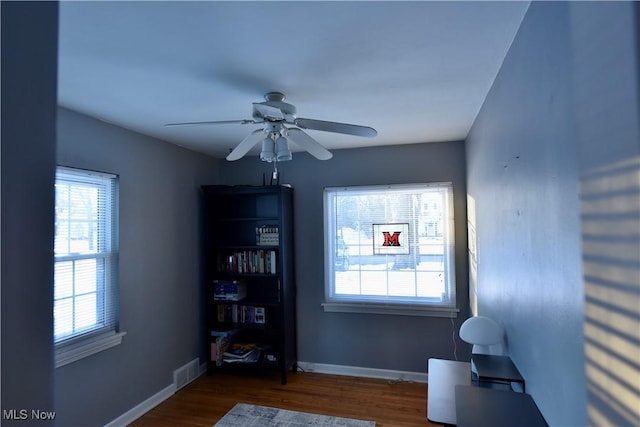 interior space with dark hardwood / wood-style floors and ceiling fan