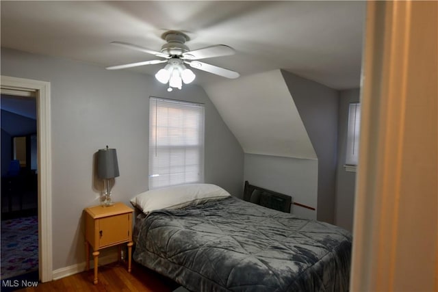 bedroom with ceiling fan, hardwood / wood-style floors, and lofted ceiling