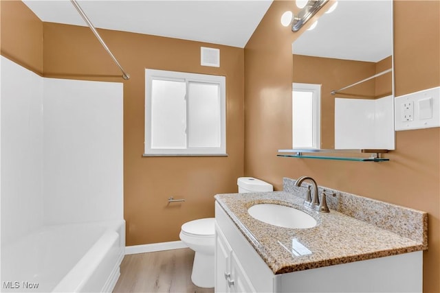 full bathroom with hardwood / wood-style floors, toilet, vanity, and bathing tub / shower combination