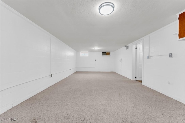 unfurnished room featuring a textured ceiling and a wall mounted AC