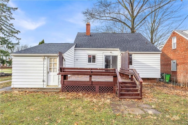 back of property featuring a deck and a yard