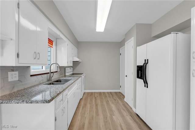 kitchen with sink, white cabinetry, white appliances, and light stone counters