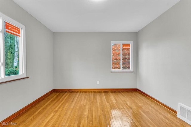 spare room featuring light wood-type flooring