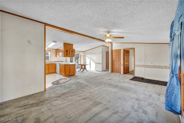 unfurnished living room featuring light carpet, a textured ceiling, lofted ceiling, and ornamental molding