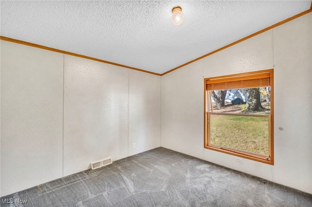 spare room featuring a textured ceiling, vaulted ceiling, crown molding, and carpet flooring