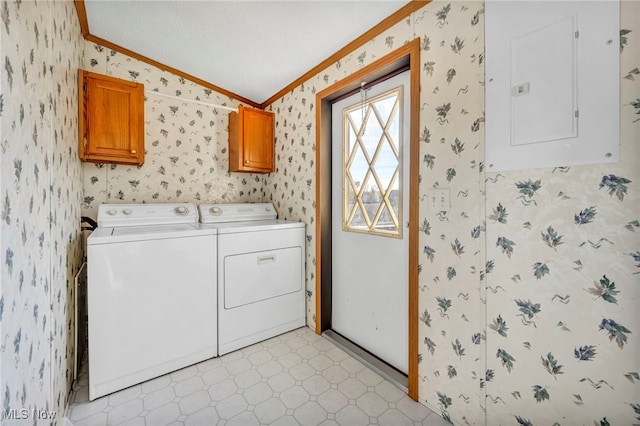 washroom featuring washing machine and clothes dryer, electric panel, cabinets, and ornamental molding