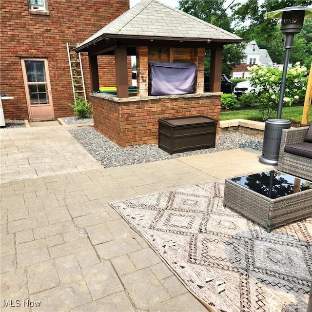 view of patio / terrace featuring a gazebo and a bar