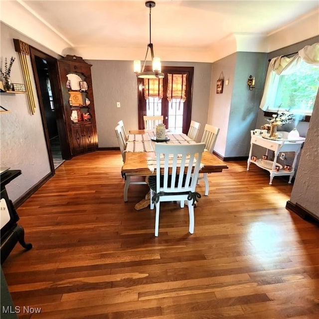 dining area featuring a chandelier and hardwood / wood-style floors