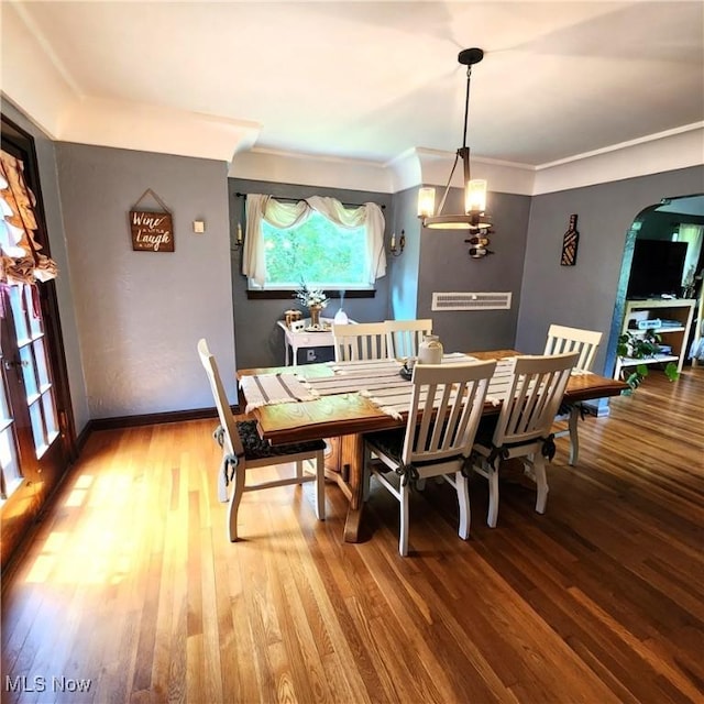 dining area featuring hardwood / wood-style flooring and ornamental molding