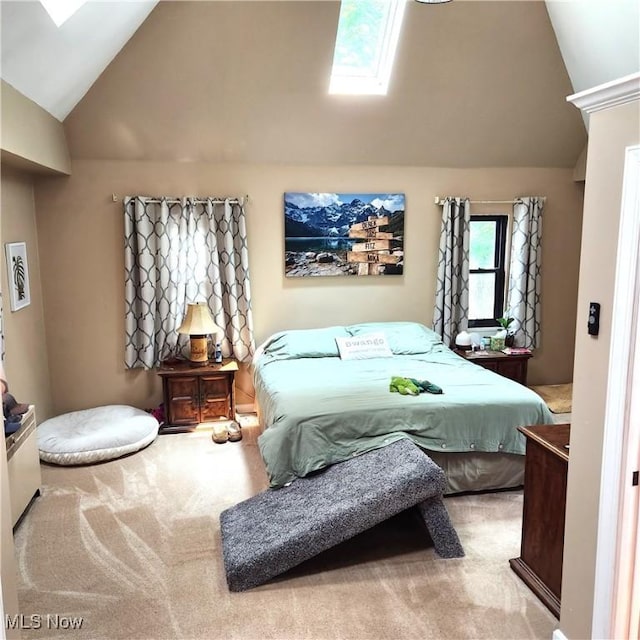 bedroom with vaulted ceiling with skylight and carpet floors