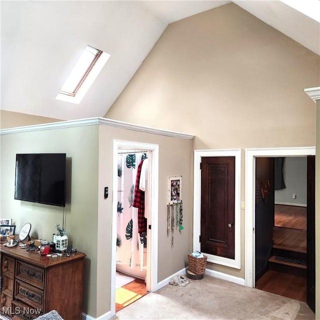 carpeted bedroom with lofted ceiling with skylight