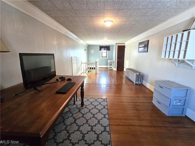 office space with hardwood / wood-style floors, ornamental molding, and radiator heating unit