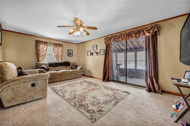 carpeted living room featuring crown molding, a textured ceiling, and ceiling fan