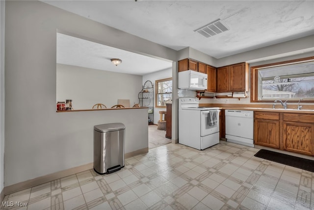 kitchen featuring white appliances and sink