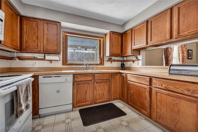 kitchen with sink and white appliances