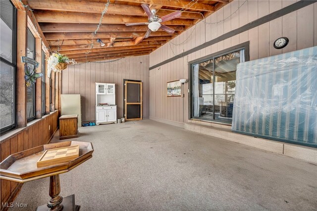 misc room featuring ceiling fan, vaulted ceiling, and carpet