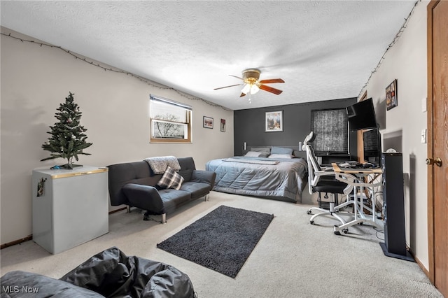 bedroom featuring ceiling fan, light colored carpet, and a textured ceiling