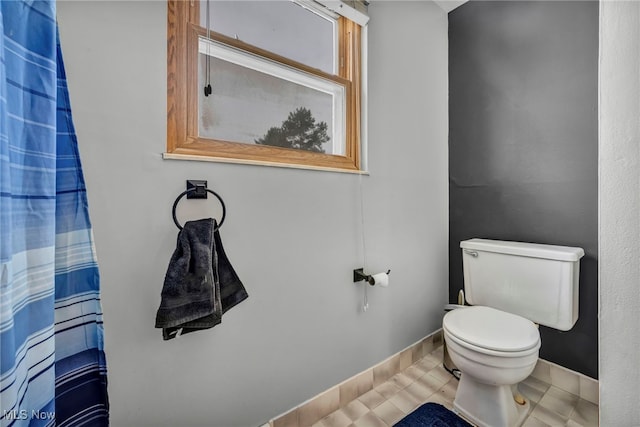 bathroom with tile patterned floors and toilet