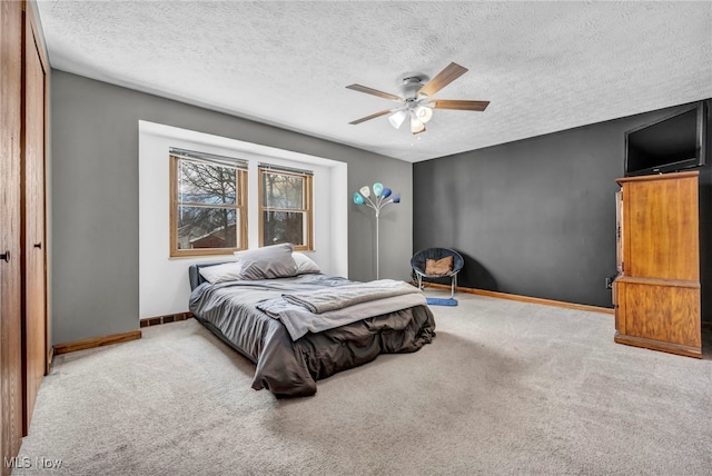 carpeted bedroom with a textured ceiling and ceiling fan