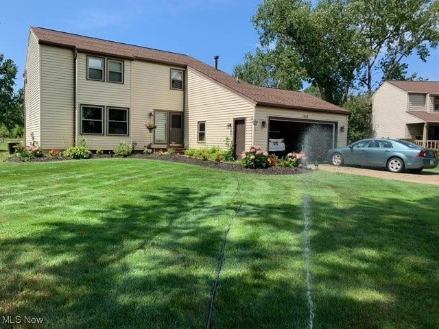 exterior space with a garage and a front lawn