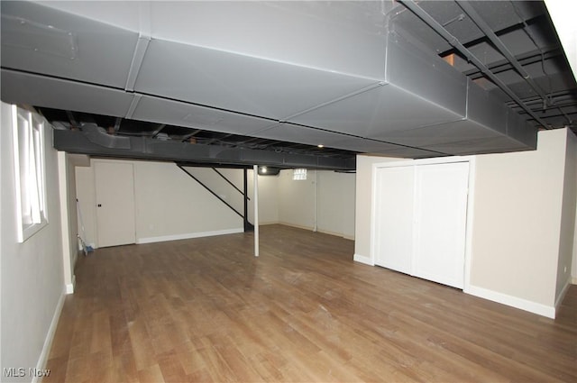 basement featuring hardwood / wood-style flooring and a wealth of natural light