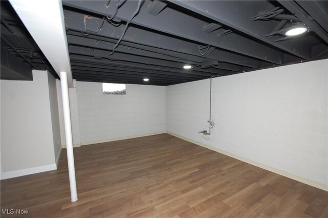 basement with hardwood / wood-style flooring