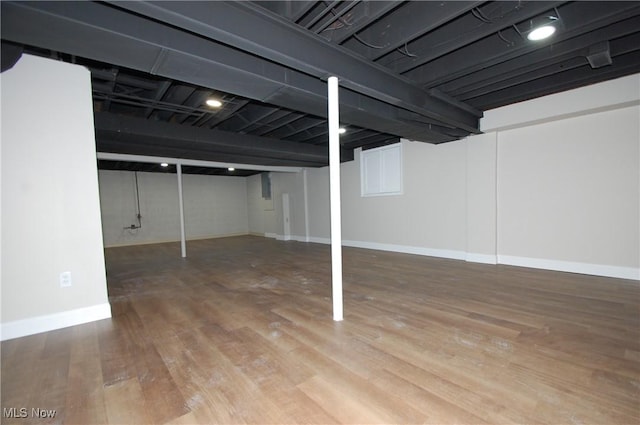 basement with hardwood / wood-style flooring