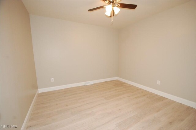 empty room featuring ceiling fan and light wood-type flooring