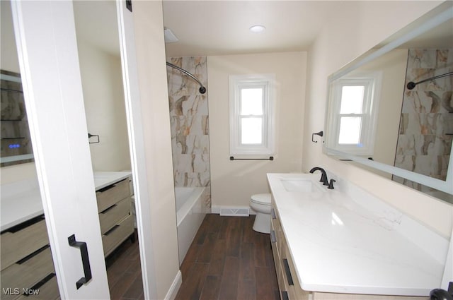 full bathroom with vanity, toilet, and tiled shower / bath combo