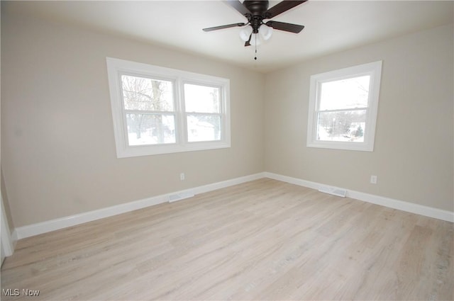 unfurnished room featuring ceiling fan, plenty of natural light, and light hardwood / wood-style floors