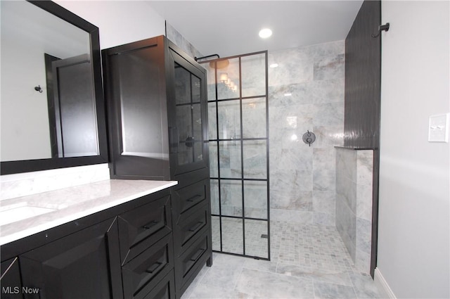 bathroom featuring vanity and tiled shower