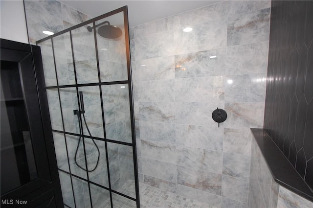 bathroom with a tile shower