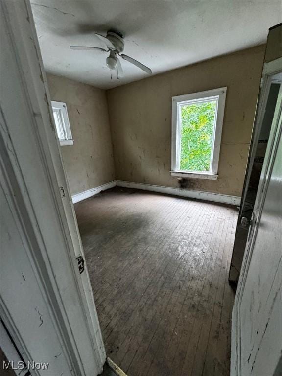 unfurnished room featuring ceiling fan and hardwood / wood-style floors