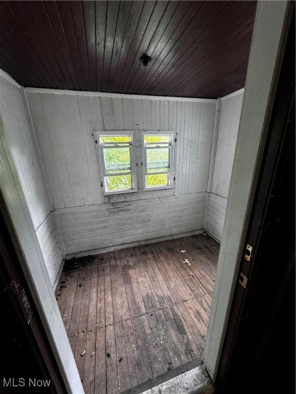 spare room featuring hardwood / wood-style flooring and wood ceiling