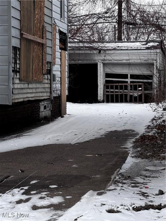 snow covered property featuring a garage