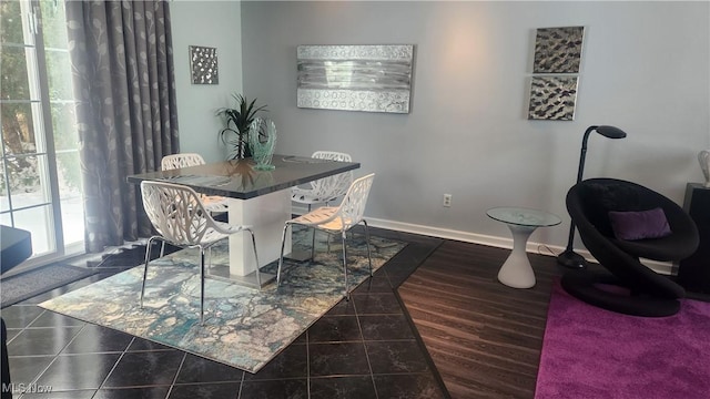 dining space featuring dark tile patterned flooring