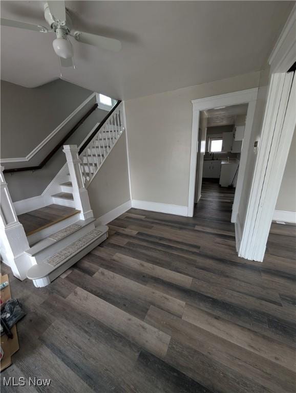 staircase featuring hardwood / wood-style flooring and ceiling fan