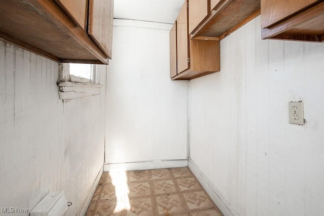 interior space with wood walls and parquet flooring