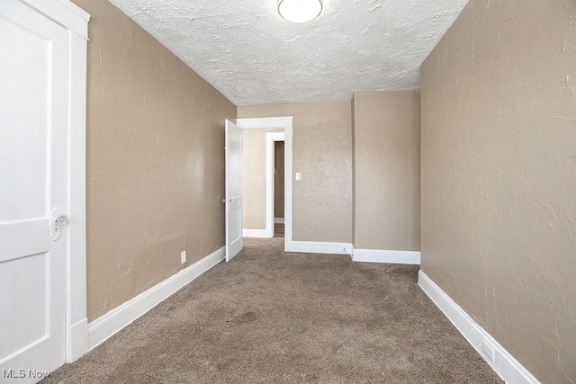 spare room with carpet floors and a textured ceiling