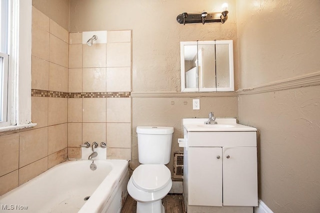 full bathroom featuring toilet, vanity, and tiled shower / bath