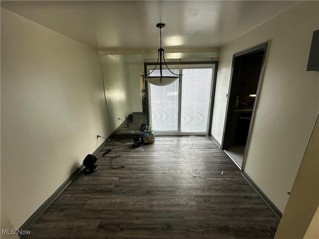 unfurnished dining area with dark wood-type flooring