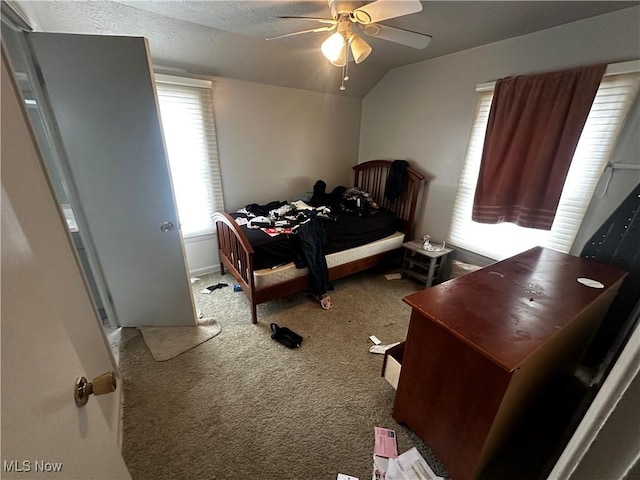 carpeted bedroom with ceiling fan, a textured ceiling, and lofted ceiling