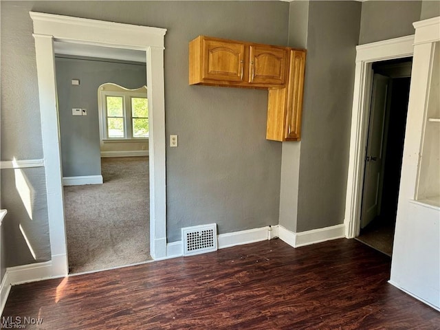 unfurnished room featuring dark hardwood / wood-style flooring