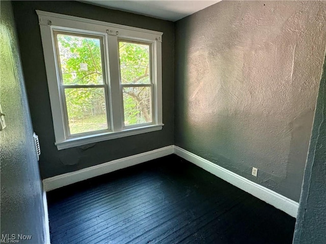 unfurnished room featuring dark hardwood / wood-style flooring