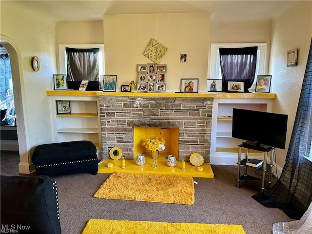 carpeted living room with a fireplace