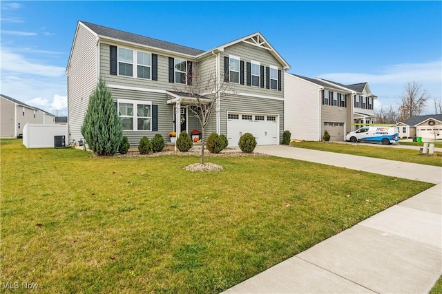 view of front of home with a garage, central AC, and a front lawn