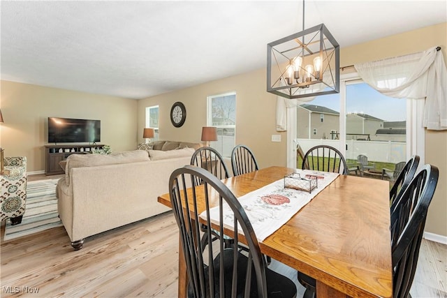 dining room featuring light hardwood / wood-style floors and an inviting chandelier