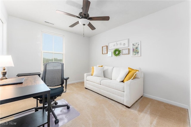 office space with ceiling fan and light carpet