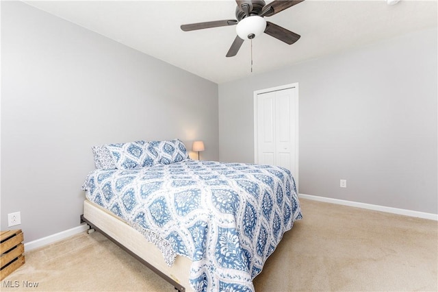 carpeted bedroom with a closet and ceiling fan